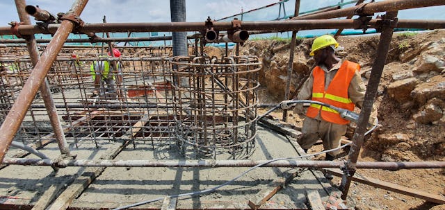A worker carefully prepares the Temple’s foundation.