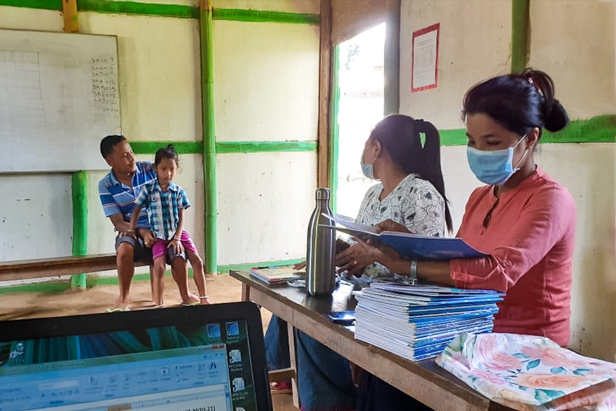 Teachers at a Bahá’í-inspired community school in Langathel, Manipur, India, distribute schoolwork to parents to carry out with their children at home as a precautionary measure during the health crisis. Bahá’í-inspired community schools in places with limited web accessibility have found creative ways of adapting to present circumstances and serving their students’ educational needs.