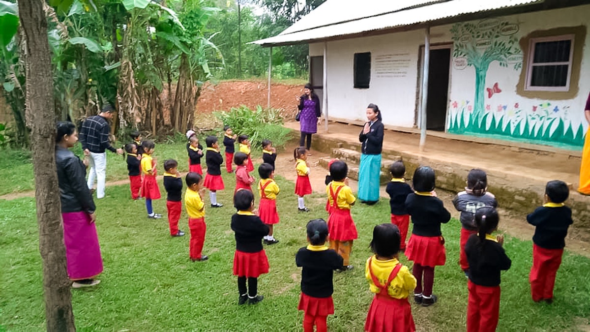 Photograph taken before the current health crisis. Teachers and children at a community school in Langathel, Manipur, India. Decades of grassroots educational efforts of Baha’is in several countries have led to the emergence of community schools, drawing on the capacity and resources that exist in a local area.
