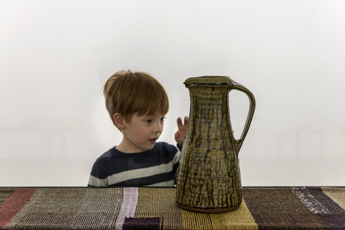 A young visitor examines a Bernard Leach jug at the installation, Kai Althoff goes with Bernard Leach at the Whitechapel Gallery, London, 7 October 2020 – 10 January 2021. Photo: Polly Eltes