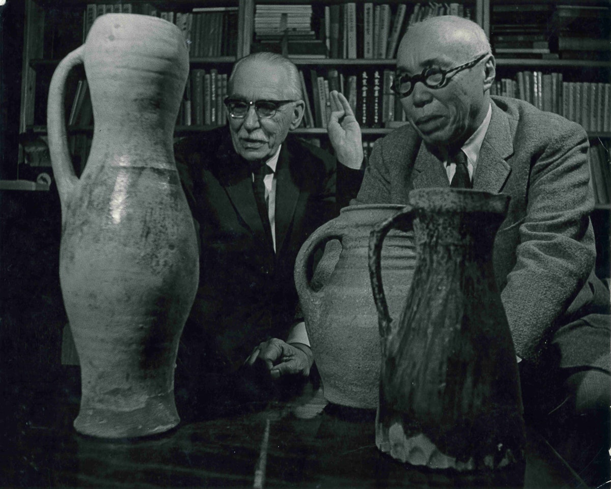 Bernard Leach and Shoji Hamada admiring an English medieval pitcher, 1966. From the Bernard Leach archive at the Crafts Study Centre, University for the Creative Arts, BHL/12872.