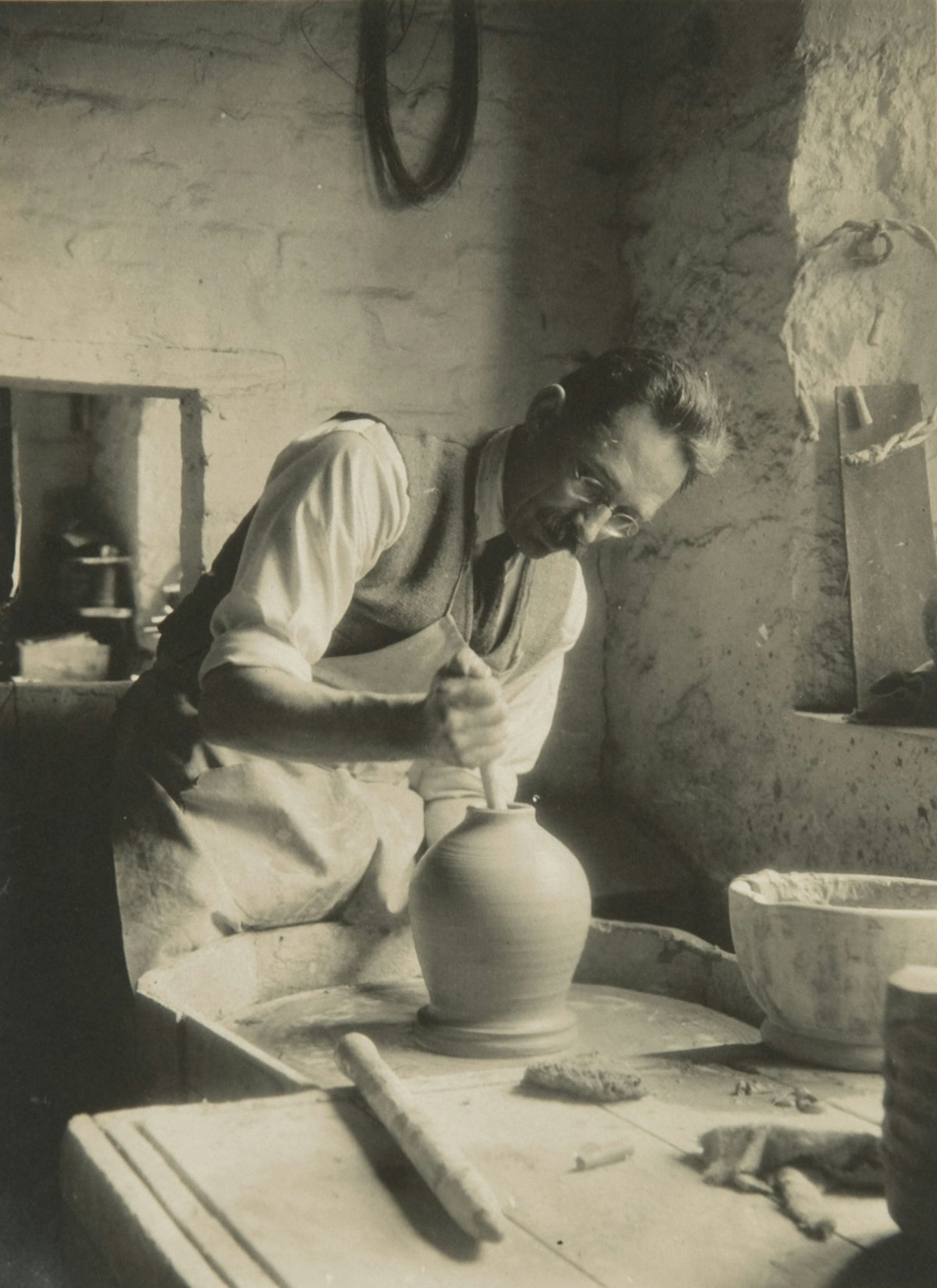 Bernard Leach travaillant au tour dans les années 1930. Provenant des archives Bernard Leach au Crafts Study Centre, université des Arts créatifs, BHL / 6690.