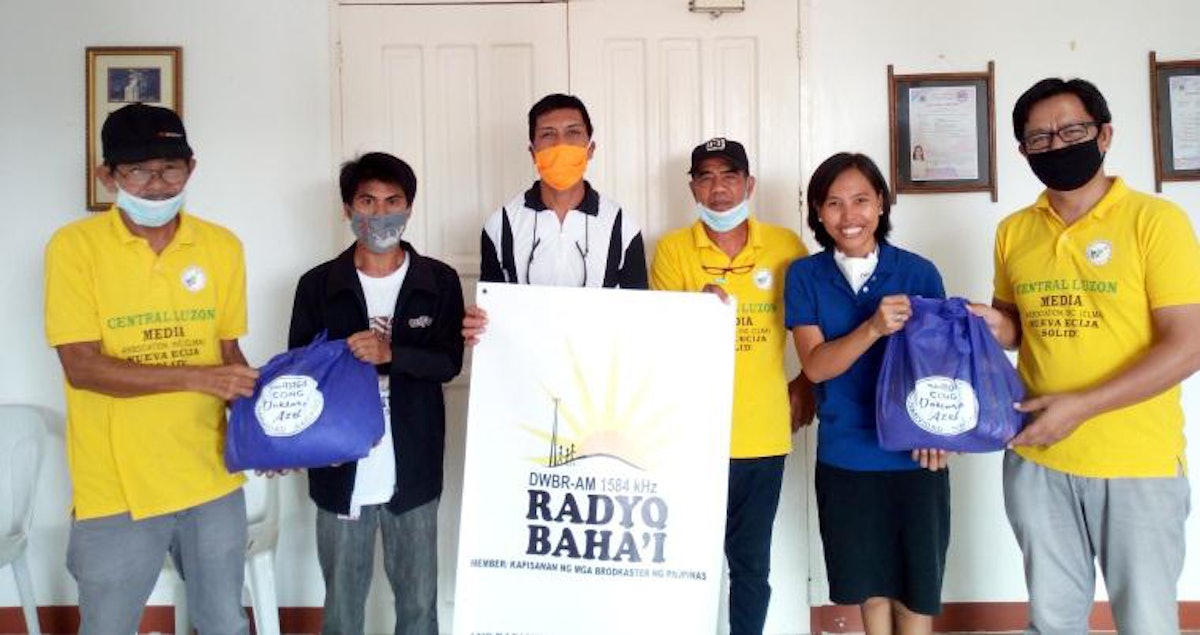 El personal de Radyo Bahá’í de Filipinas colaboran con los miembros de la Asociación de Medios de Luzón Central en la distribución de ayuda en la región.