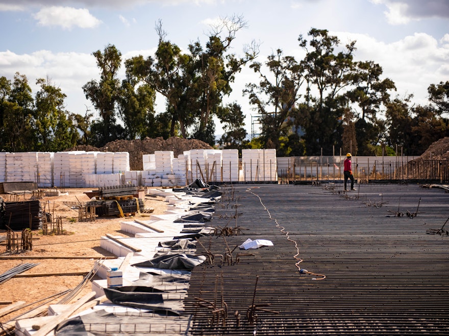 Once “void former” blocks are put in place, reinforcement bars are laid for the concrete pour.