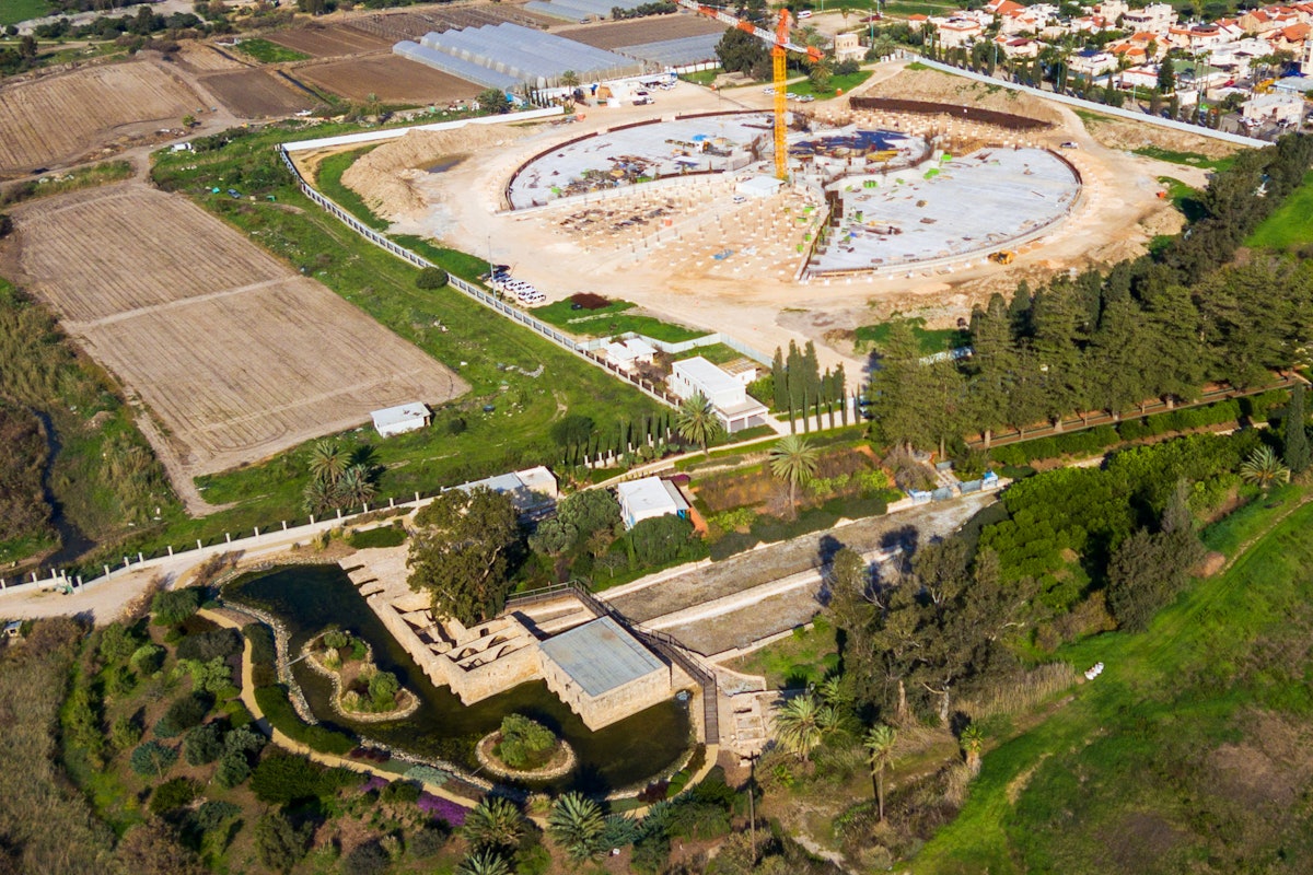 An aerial view shows recent progress in the construction work for the Shrine of ‘Abdu’l-Bahá. The site for the Shrine is located near the Riḍván Garden, which is visible in the foreground.