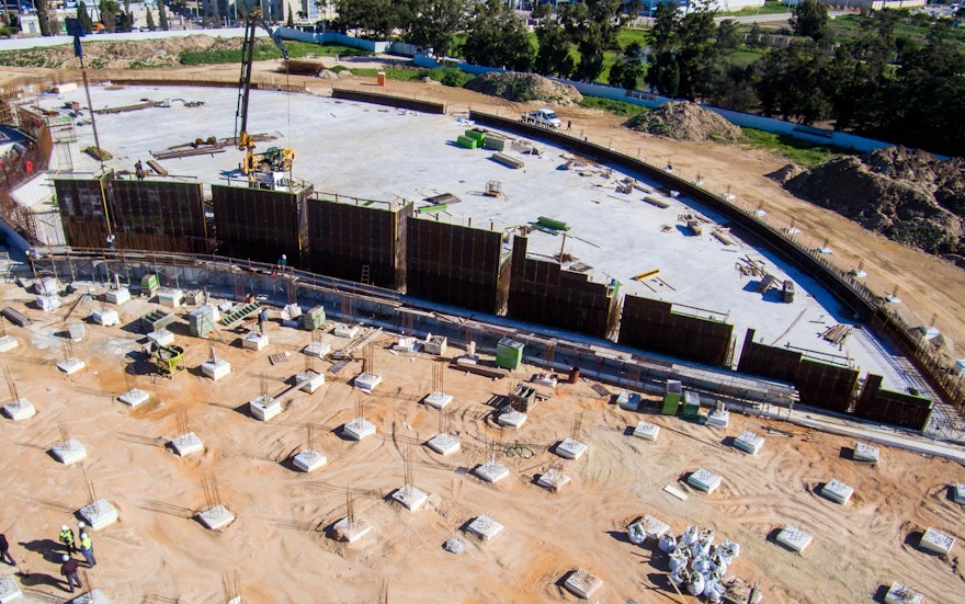 The structural reinforcement and formwork for one of the walls enclosing the south plaza are being assembled.
