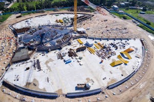 Custom-made formwork that will be used to mold plaza walls has been assembled as berm walls rise and work on garden paths advances.