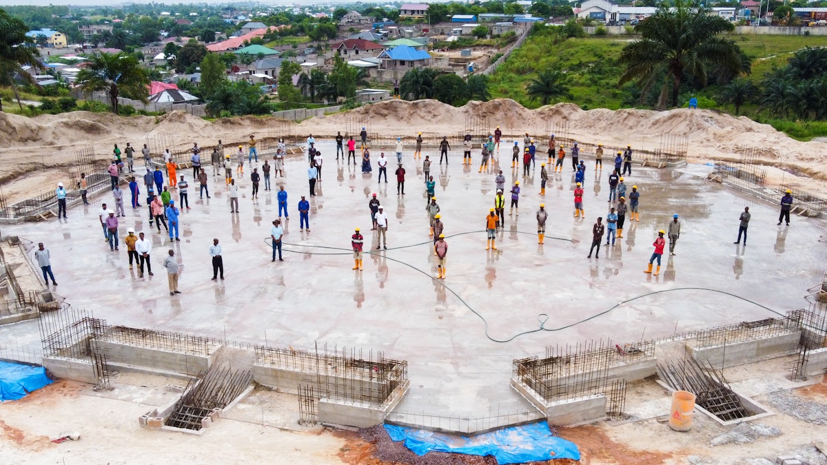 The staff who have been working on the construction of the temple gathered Thursday on the newly completed floor slab to mark this key milestone in the project.