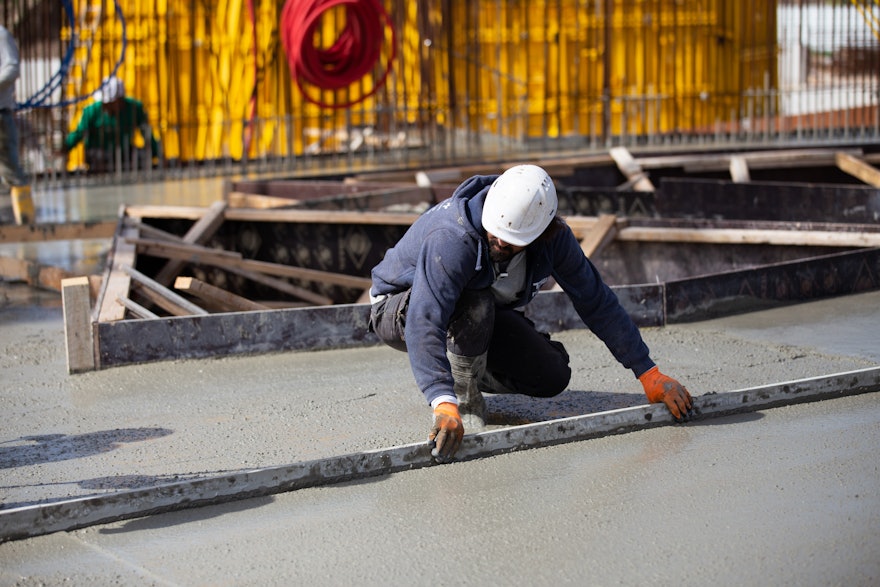 The concrete surface of the floor slab is smoothed after pouring.