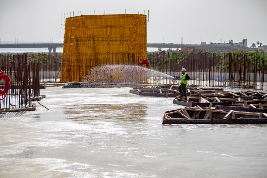 Once the concrete of the plaza floor sets, the construction of the folding walls around the plaza and the pillars of the main edifice can proceed.