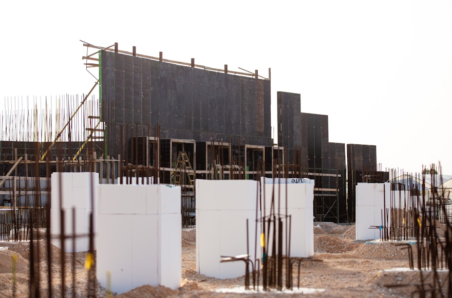 Work continues to advance on the portal walls enclosing the north and south plazas, as well as the pillars that will support the floor of the north plaza (foreground).