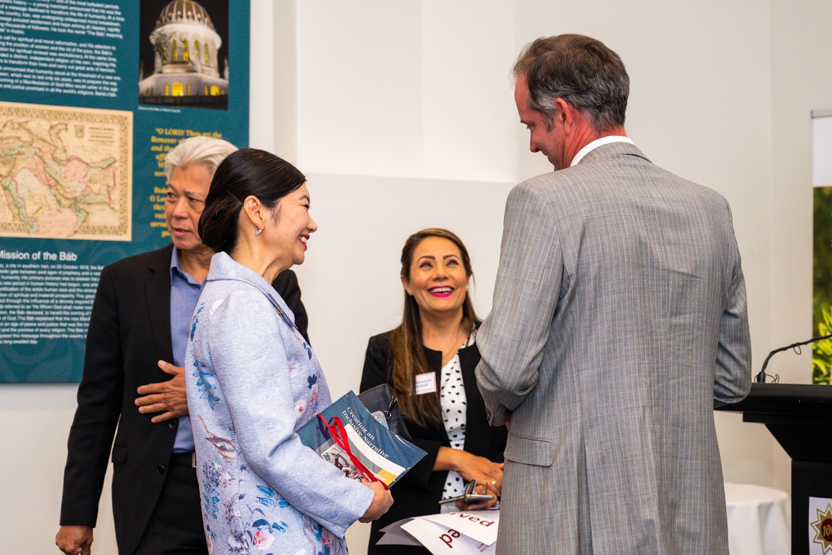 In-person gatherings held according to safety measures required by the government. Jing Lee (left), the assistant minister to the premier of the state of South Australia, speaks with representatives of the Bahá’í community at a gathering in Adelaide, South Australia.