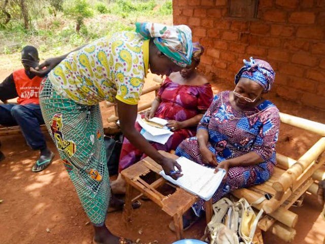 Relief efforts carried out according to safety measures required by the government. Members of the emergency committee and of a Bahá’í Local Spiritual Assembly work together in coordinating the distribution of relief packages among village residents.