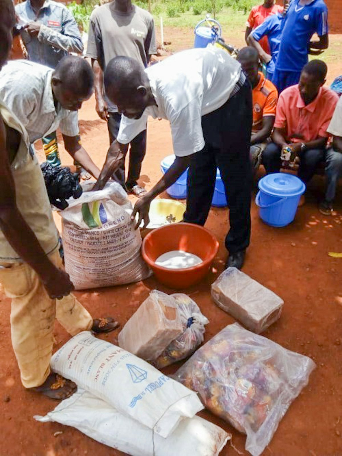Relief efforts carried out according to safety measures required by the government. In an effort coordinated by the emergency committee established by the National Spiritual Assembly, essential supplies are distributed in a community affected by conflict.