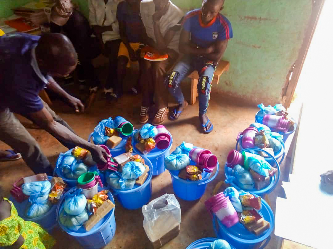 Relief efforts carried out according to safety measures required by the government. Packages of supplies prepared with the assistance of the emergency committee are prepared for residents of a village in the Central African Republic.