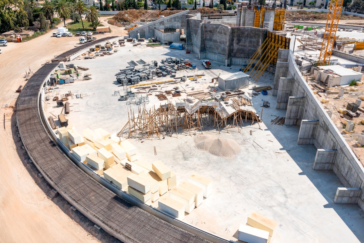 The completed set of folding walls are being joined with one of the portal walls of the south plaza. Also visible on the left of this image are the foundations constructed for the path encircling the Shrine. The space between the path and the walls will eventually be filled with a sloping garden berm.