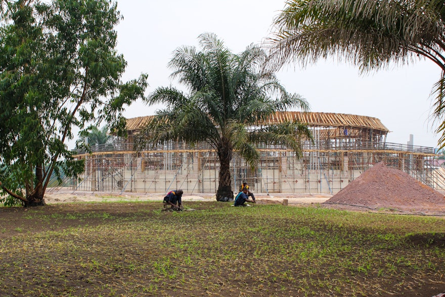 Work on the grounds and auxiliary structures around the temple continues. Here, gardeners plant a lawn near the rising temple.