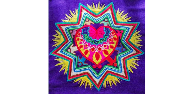 This mandala was embroidered by a Bolivian artist who was inspired by ‘Abdu’l-Bahá’s immense love for all of humanity.