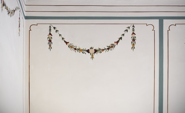 A close-up view of the traditional floral paintings that had been plastered over many years ago, which have now been restored by conservators.