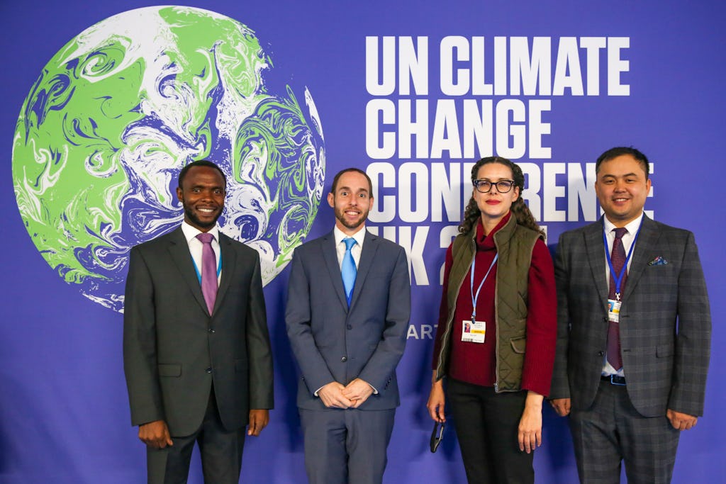 Représentants de la Communauté internationale bahá’íe (BIC) à la COP26. De gauche à droite : Peter Aburi du Kenya, Daniel Perell du Bureau de New York du BIC, Maja Groff des Pays-Bas et Serik Tokbolat du Kazakhstan. (Crédit : Kiara Worth)