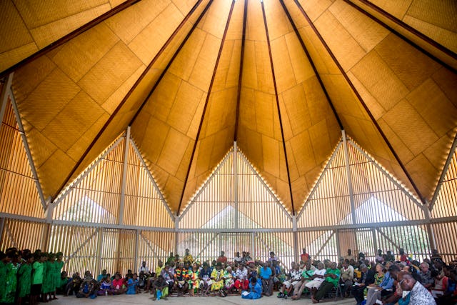 Participants gathered in small groups inside the temple for a devotional program.