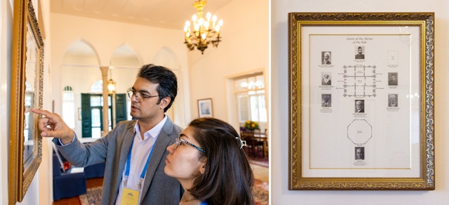 Two participants viewing a diagram (close-up on the right) depicting the arrangement of the rooms and doors to the Shrine of the Báb.