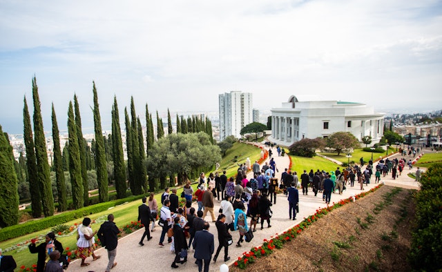 Participants leaving the Seat of the Universal House of Justice following the close of the morning’s program.