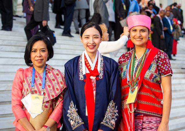 A group of attendees from different countries waiting with anticipation for the start of the program.