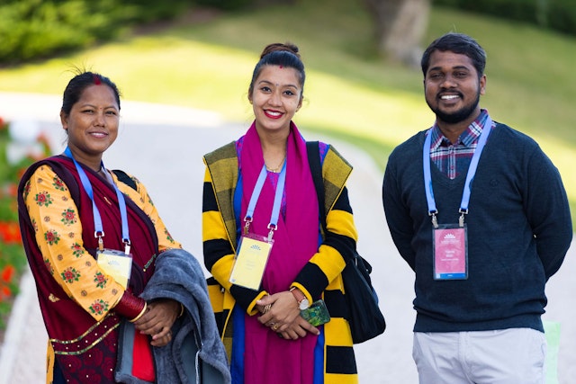 Attendees on a path near the Seat of the Universal House of Justice.