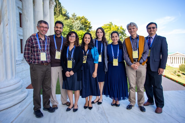 Participants gathered for a group photo near the entrance to the concourse of the Seat of the Universal House of Justice.