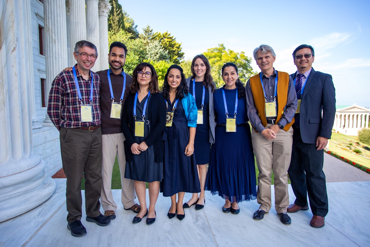 Participants gathered for a group photo near the entrance to the concourse of the Seat of the Universal House of Justice.