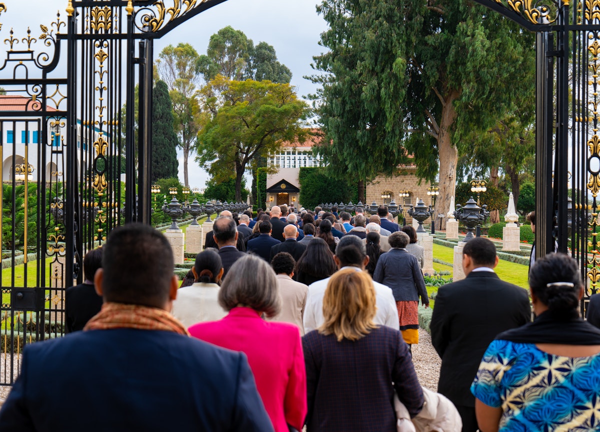The Counsellors visiting the Shrine of Bahá’u’lláh in procession to pray for the well-being of humanity.