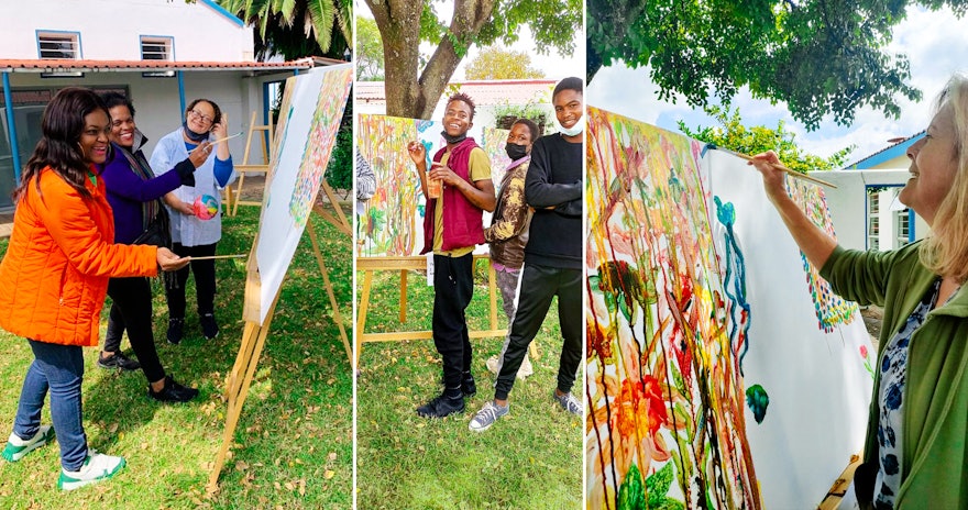 At a gathering in South Africa, youth and adults created collaborative multicolored paintings symbolizing unity diversity.
