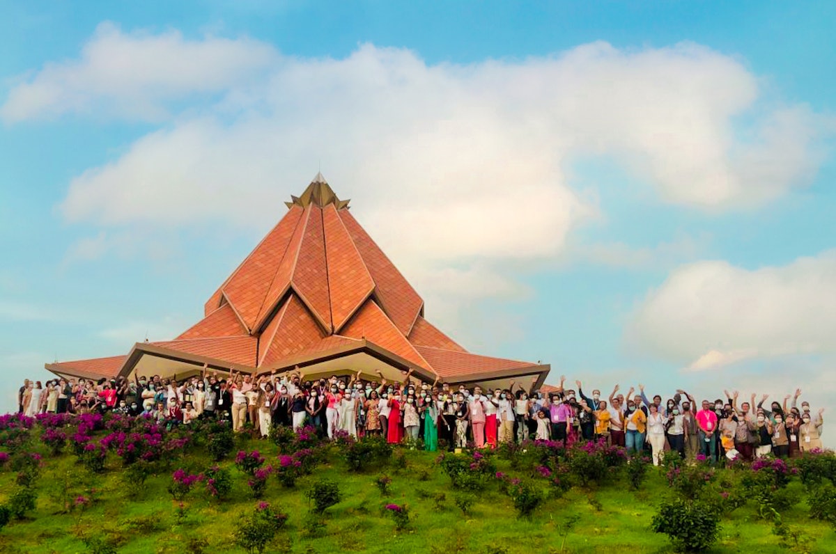 Participants of a local conference stand in front of the Baháʼí House of Worship in Norte del Cauca, Colombia, for a group photo.