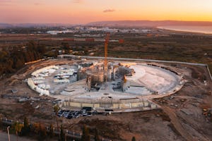 Construction work continues on the Shrine of ‘Abdu’l-Bahá, with work on the concrete base layer of the west berm nearly completed.