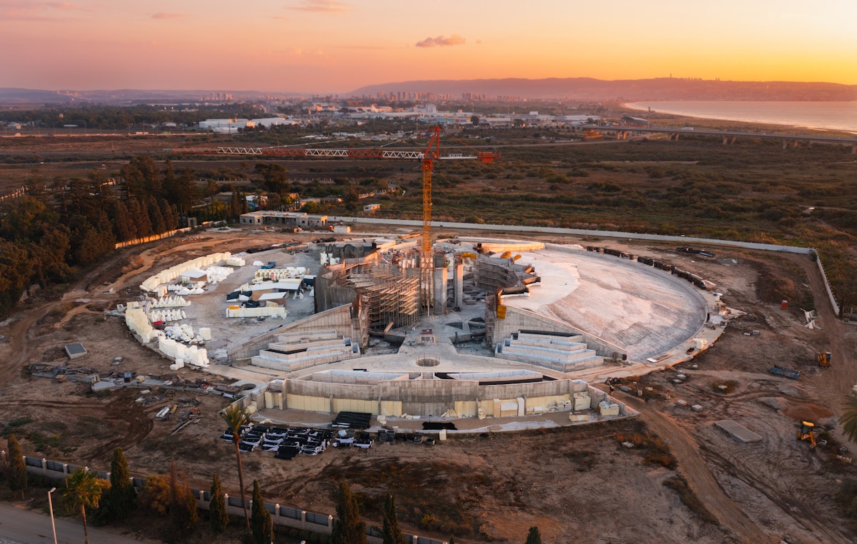 Construction work continues on the Shrine of ‘Abdu’l-Bahá, with work on the concrete base layer of the west berm nearly completed.