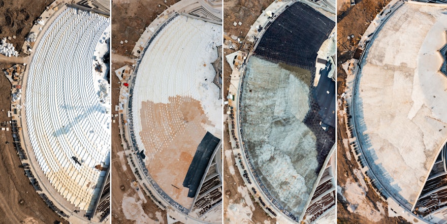 In preparing the berms, expanded polystyrene (EPS) blocks are first assembled and layered to create the shape of the slope. Next, gravel is poured onto the formwork, using a specialized gravel pump, to create a smooth and continuous surface. Then, a liner is laid that will separate the concrete from the gravel. A network of rebar is placed on top of the liner to strengthen the concrete, which is finally poured on top. The concrete surface is designed to allow small service vehicles to safely drive on the berm without damaging it. When completed, the berm will be covered with topsoil, and then landscaped with grass, shrubs, and other foliage.