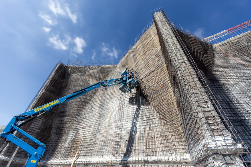 Rebar is added to the wall on the east berm to reinforce additional shotcrete—concrete that is sprayed rather than poured—that will cover the walls.