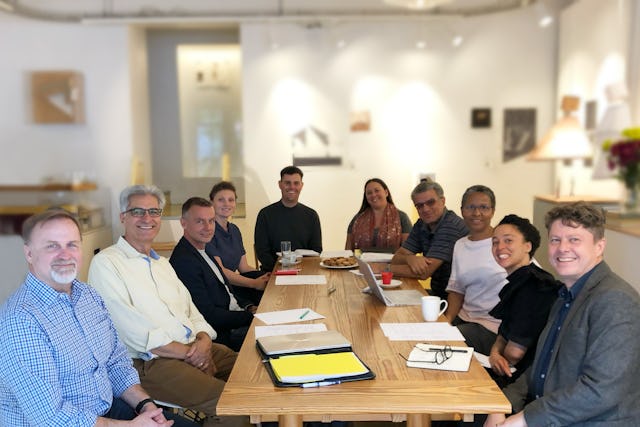 A meeting at Wolff Architects in Cape Town, South Africa, with a representative (second from left) from the Bahá’í World Centre.