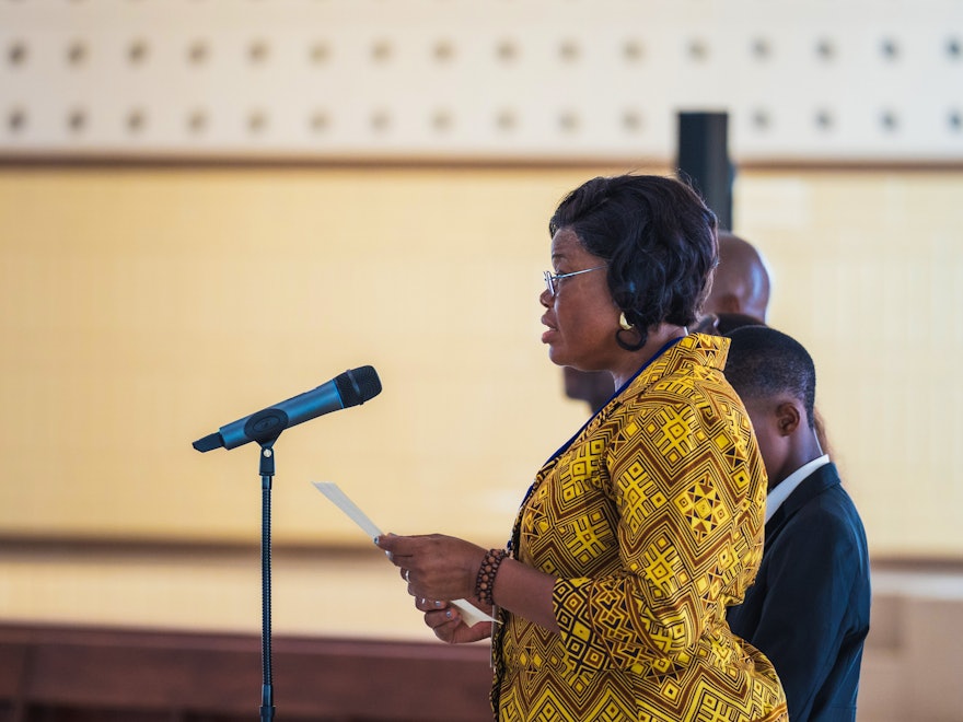 Mrs. Bangala, representative of the Universal House of Justice to the event, reads its message addressed to the gathering.