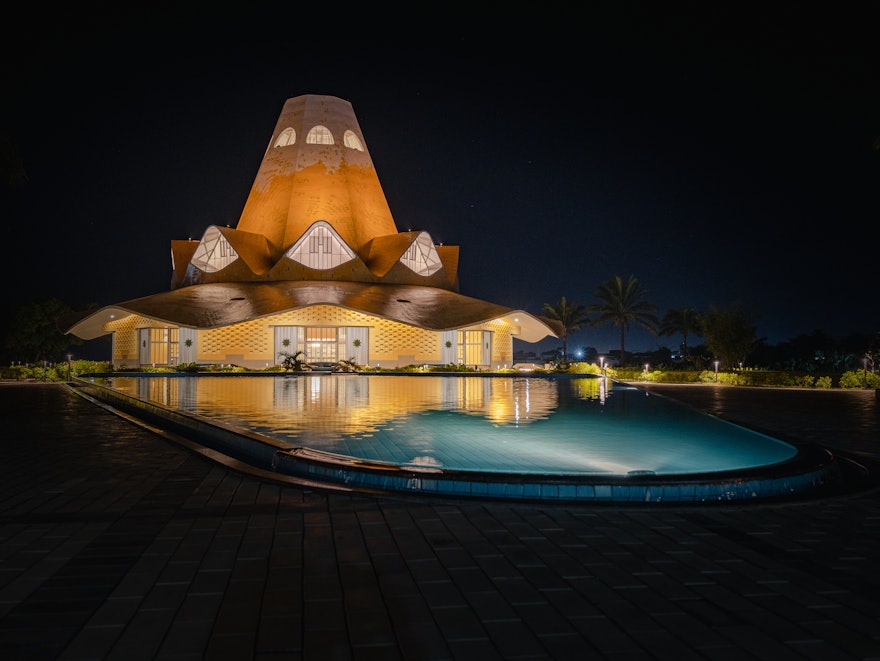 An evening view of the temple and the reflecting pool at night.