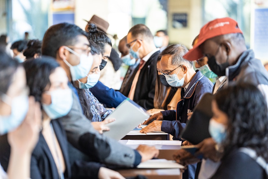 Delegates from around the world begin to register.