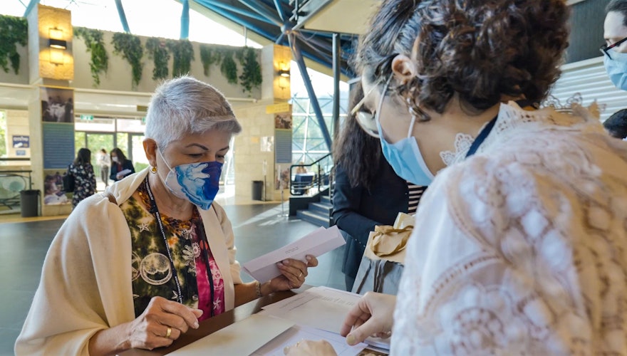 A delegate registering upon arrival.