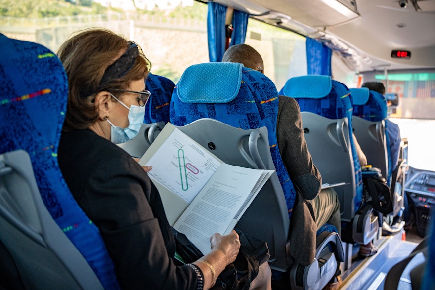 A representative reading the registration package on the way to visiting sacred Bahá’í Shrines.