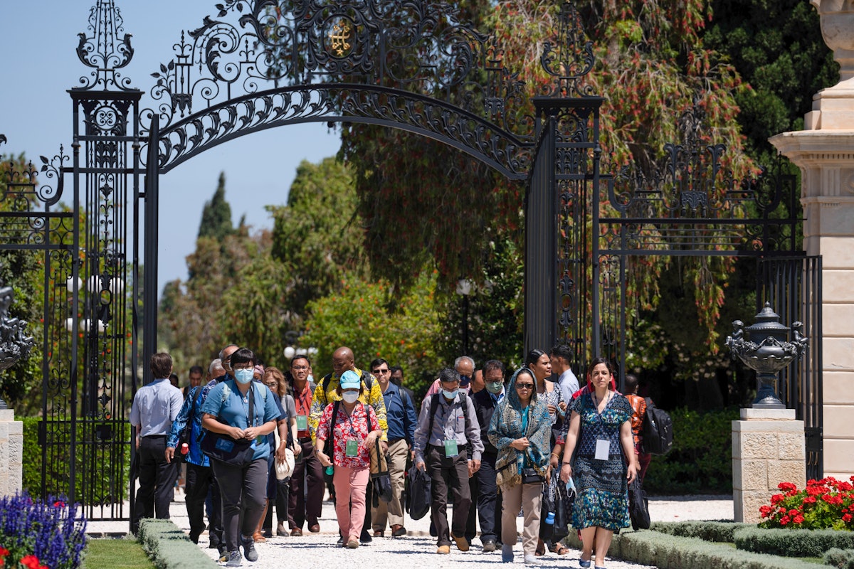 A group of delegates enter through the Collins Gate as they approach the Shrine of Bahá'u'lláh.