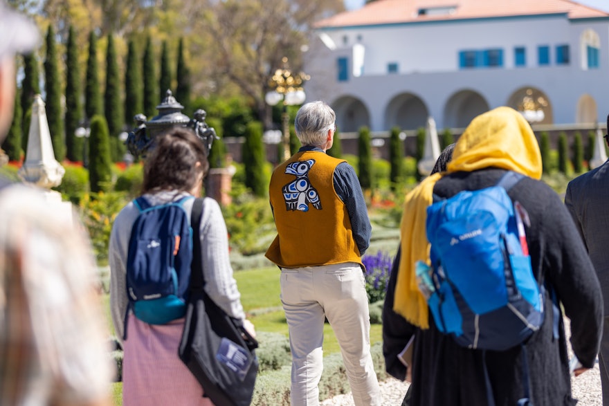 A delegate from Canada (middle) approaches the Shrine of Bahá'u'lláh, alongside other representatives from around the world.