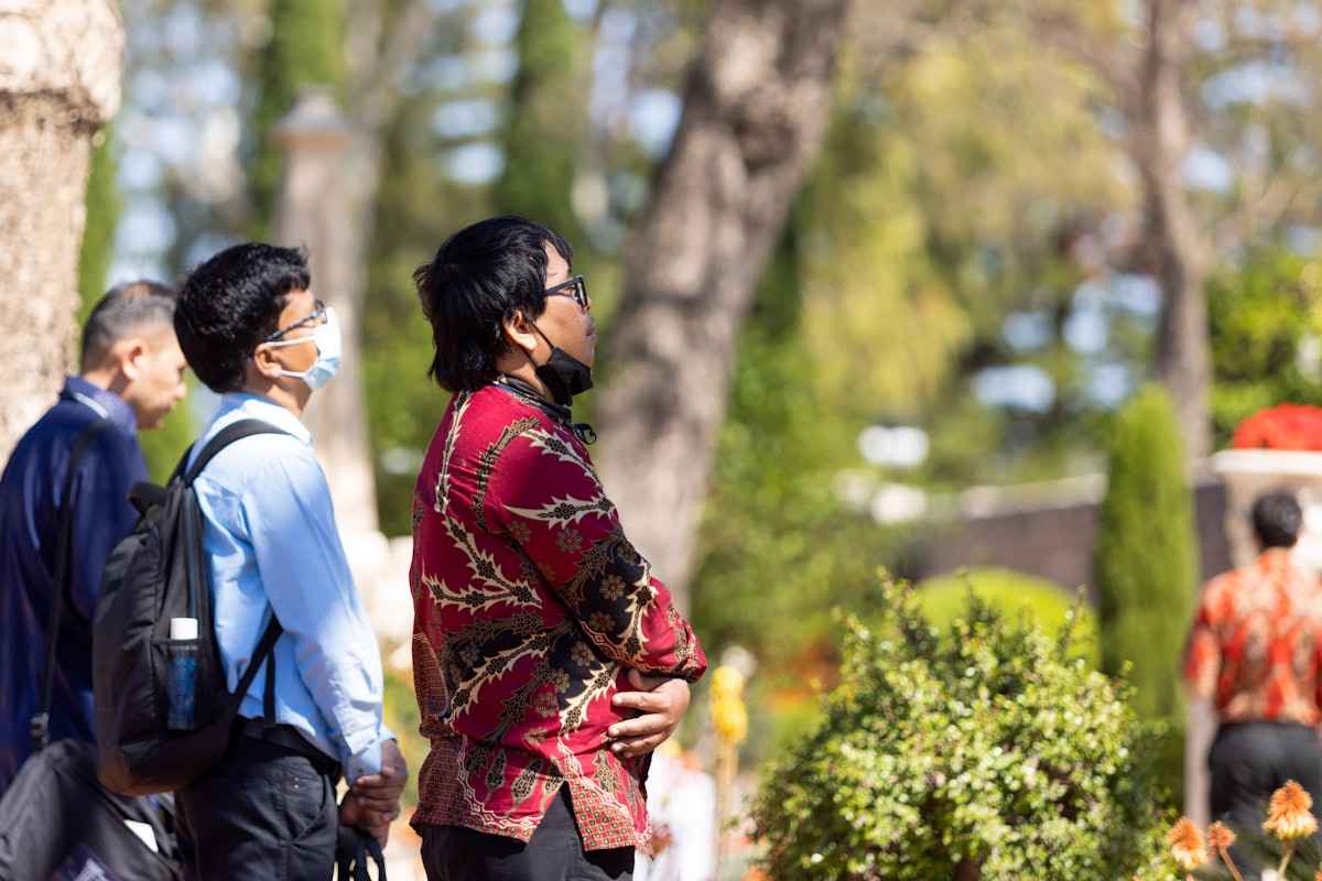 Delegates praying in the gardens surrounding the Shrine of Bahá'u'lláh.