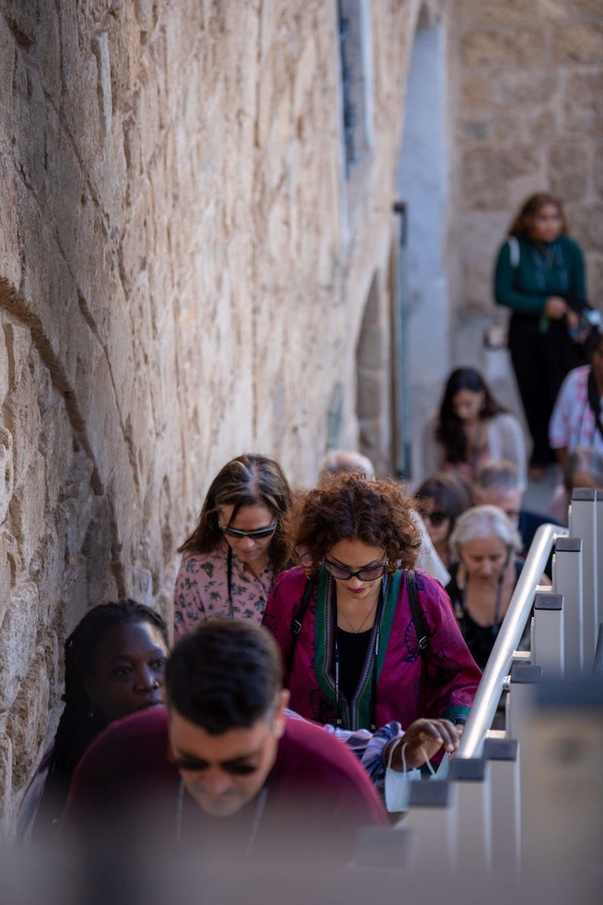 Delegates ascend a flight of stairs from the citadel courtyard toward the Prison Cell.