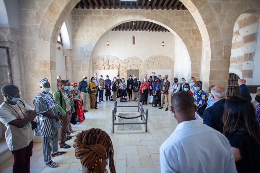 Delegates visit the spot in the Prison (roped off, center) where   Bahá’u’lláh’s son Mírzá Mihdí tragically fell to his death while praying on the roof above.