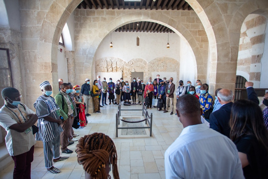 Delegates visit the spot in the Prison (roped off, center) where   Bahá’u’lláh’s son Mírzá Mihdí tragically fell to his death while praying on the roof above.